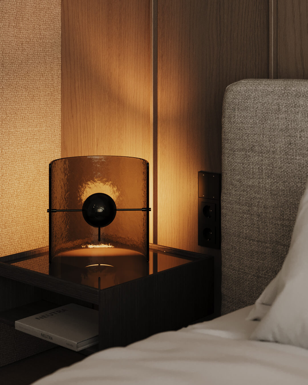 Lampa na stoliku nocnym obok łóżka. Książka