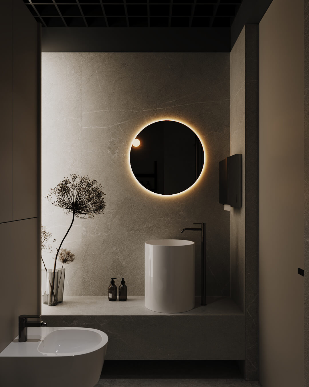 Elegancka łazienka z okrągłym lustrem z podświetleniem, umywalką i minimalistycznym wystrojem.