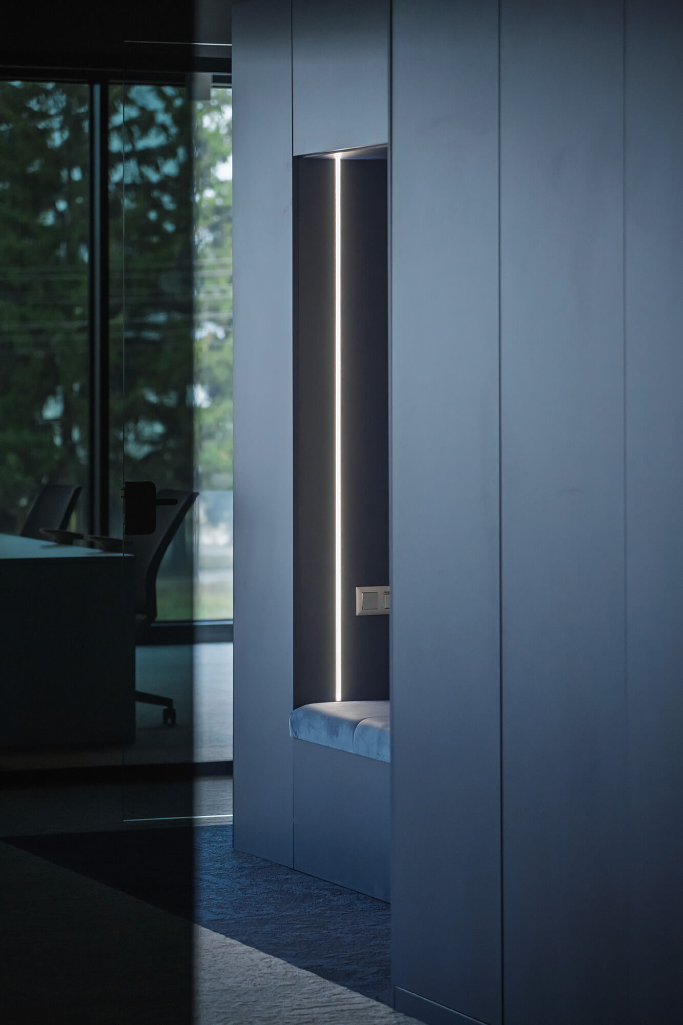 Nowoczesne wnętrze: wnęka z oświetleniem, szara tapicerka. Minimalistyczny design.