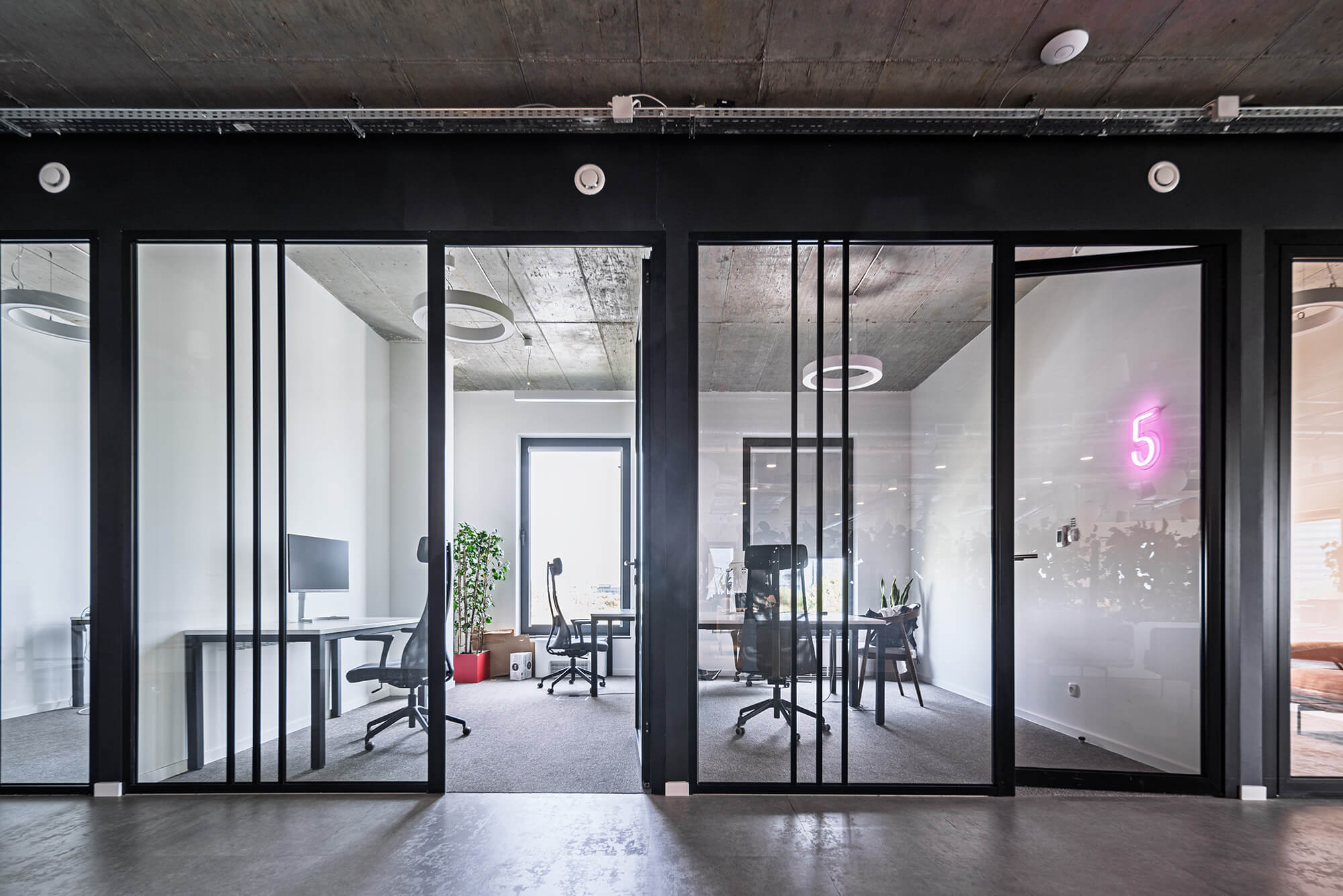 Nowoczesne biuro z przeszklonymi ścianami i minimalistycznym wystrojem. Numer 