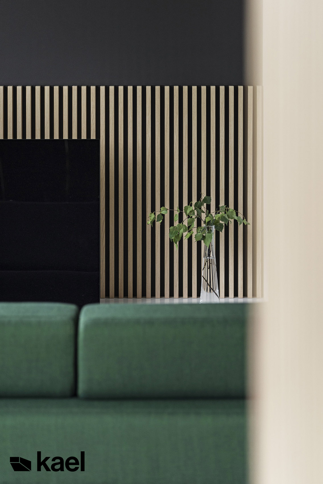 Detale - zielona sofa, roślina w wazonie